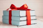 a bundle of books tied with a red ribbon